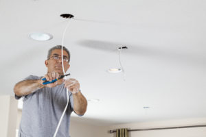 Electrician ceiling light installation.